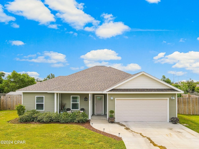 ranch-style home with a garage and a front lawn