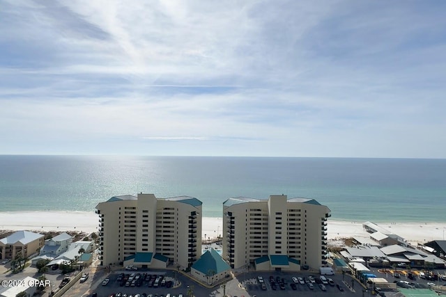 birds eye view of property with a water view and a view of the beach