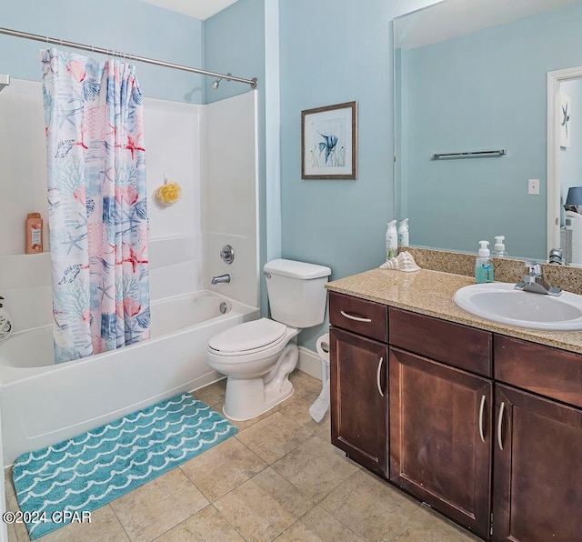 bathroom featuring toilet, shower / tub combo, vanity, tile patterned flooring, and baseboards