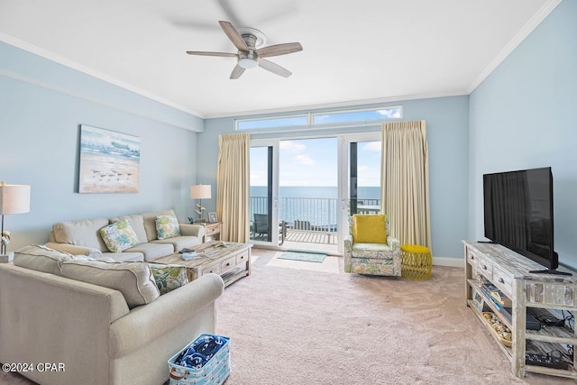 carpeted living area featuring crown molding, baseboards, and ceiling fan