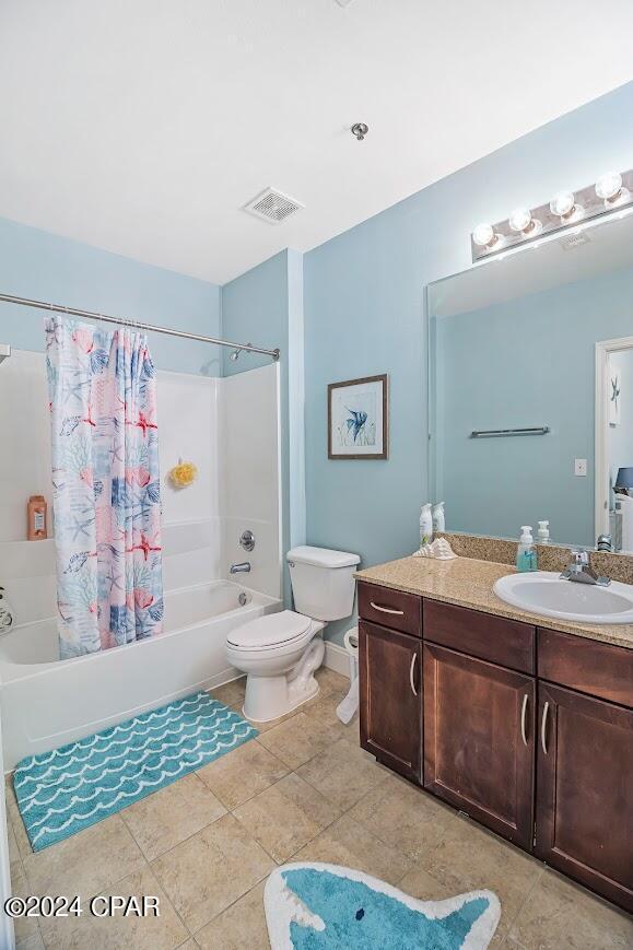 bathroom featuring shower / tub combo, visible vents, toilet, tile patterned floors, and vanity