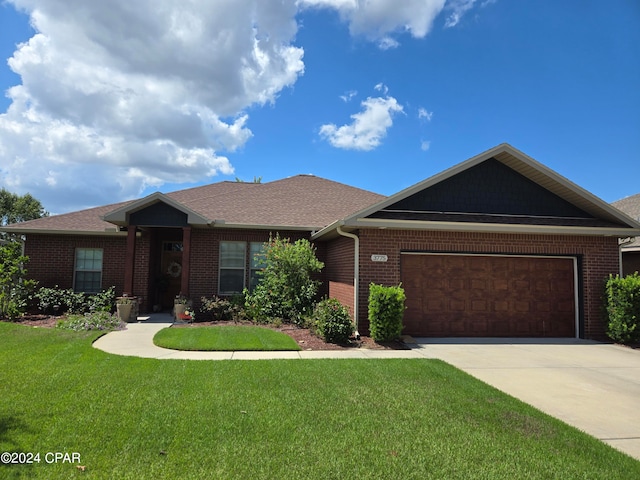 view of front of house with a front yard and a garage