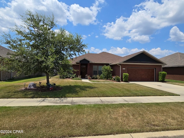 ranch-style house featuring a front yard and a garage