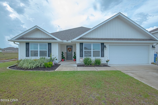 view of front of property with a garage and a front yard