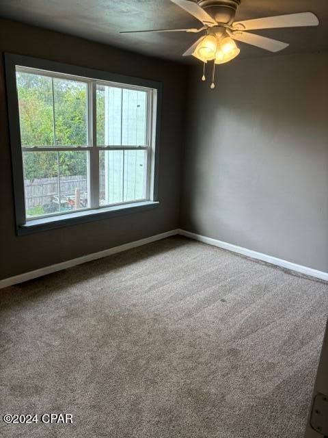 carpeted empty room with ceiling fan