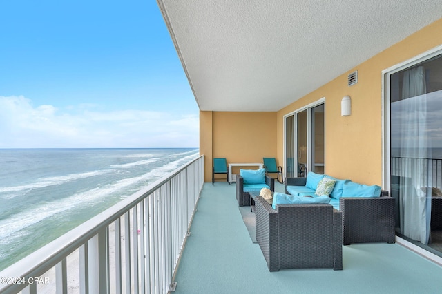 balcony featuring visible vents, a water view, and an outdoor hangout area