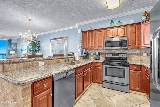 kitchen featuring backsplash, appliances with stainless steel finishes, a peninsula, an inviting chandelier, and a sink