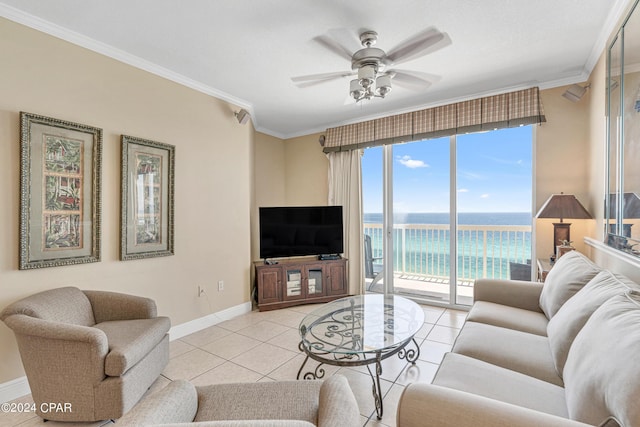 living room with light tile patterned floors, baseboards, ornamental molding, and a ceiling fan