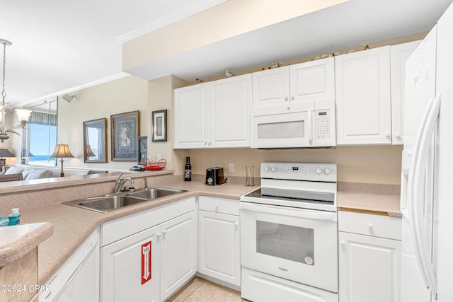 kitchen featuring light tile patterned floors, crown molding, white appliances, sink, and pendant lighting