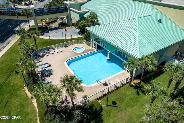 view of pool featuring a hot tub, a yard, and a patio