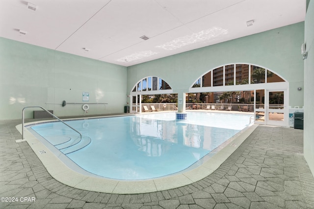 view of swimming pool featuring french doors