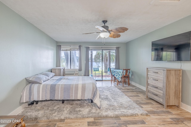 bedroom featuring ceiling fan, access to exterior, a textured ceiling, and light hardwood / wood-style floors