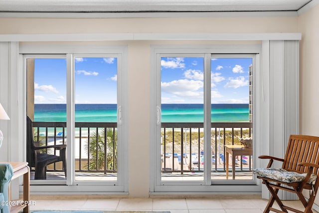 interior space featuring ornamental molding, a water view, and tile patterned floors