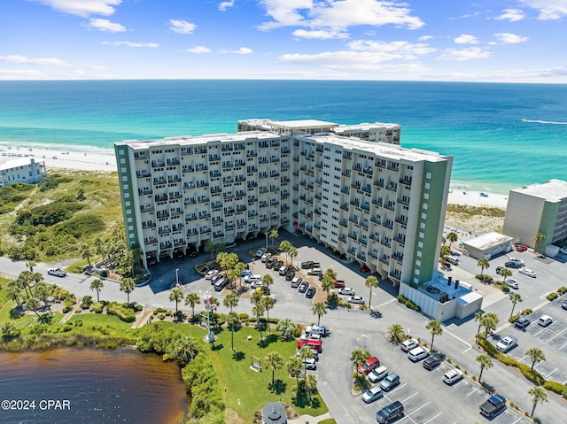 drone / aerial view with a water view and a beach view