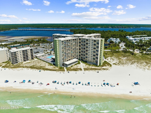 birds eye view of property featuring a beach view and a water view