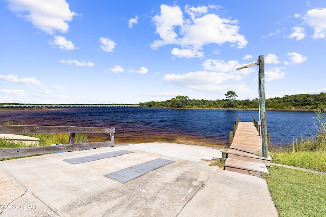 view of patio / terrace with a water view and a dock