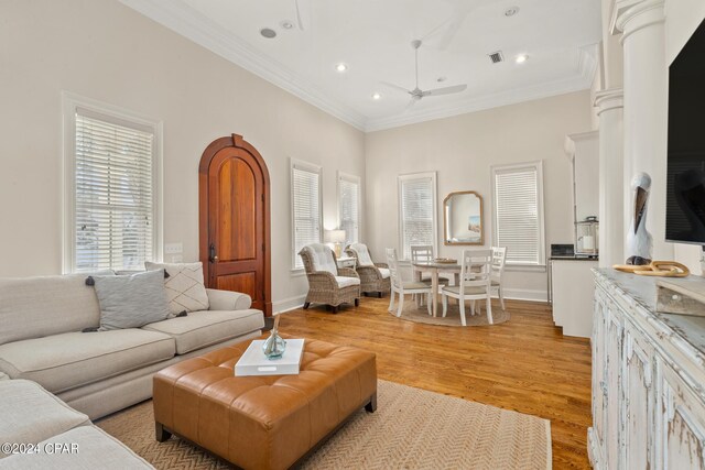 living room with light hardwood / wood-style flooring, ceiling fan, and ornamental molding