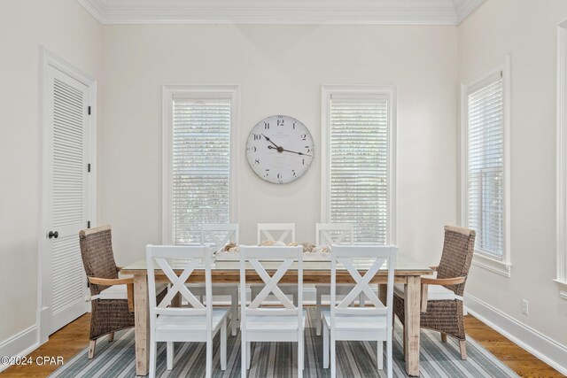 dining room with ornamental molding and hardwood / wood-style floors