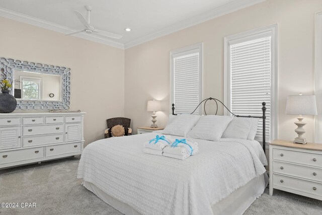 bedroom featuring ceiling fan, light colored carpet, and ornamental molding