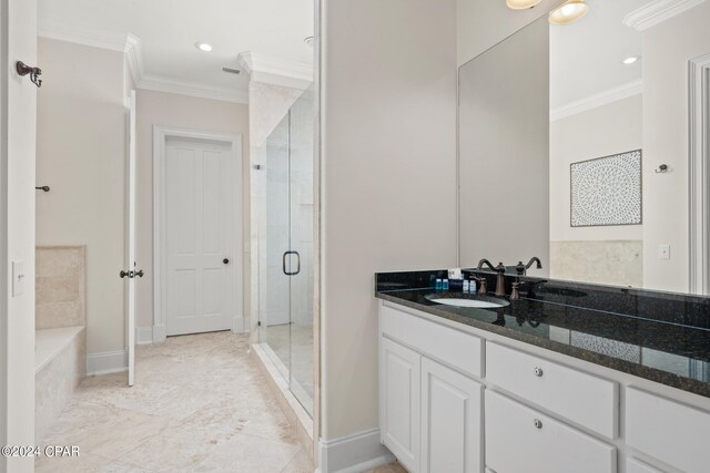 bathroom with crown molding, vanity, and separate shower and tub