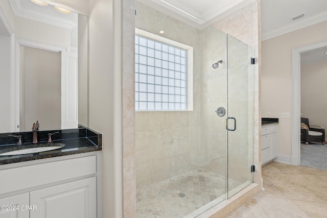 bathroom with tile patterned flooring, a shower with door, vanity, and crown molding