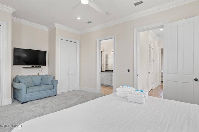 carpeted bedroom featuring ornamental molding, ceiling fan, and ensuite bathroom