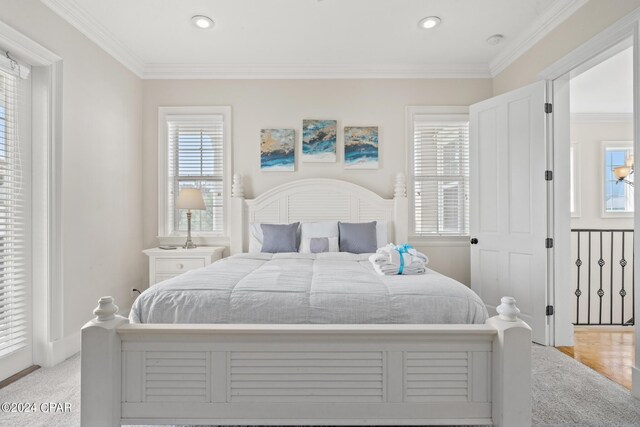 bedroom featuring ornamental molding and light colored carpet