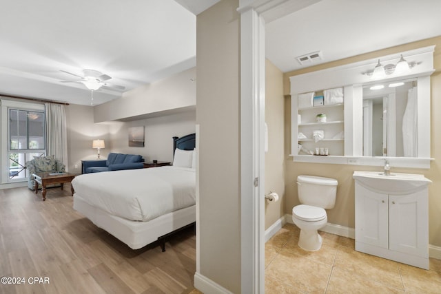 bedroom featuring light hardwood / wood-style floors, sink, and ceiling fan