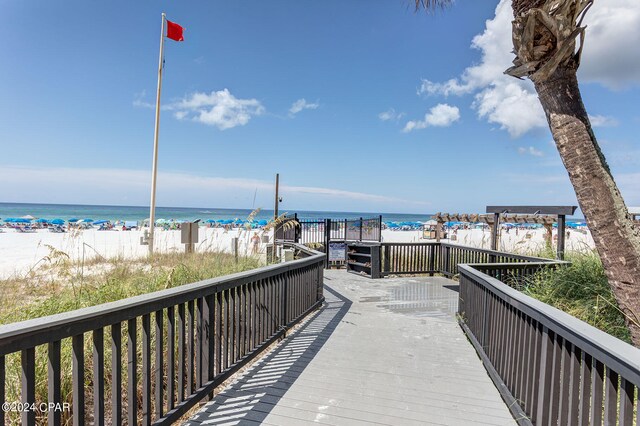 view of community featuring a beach view and a water view