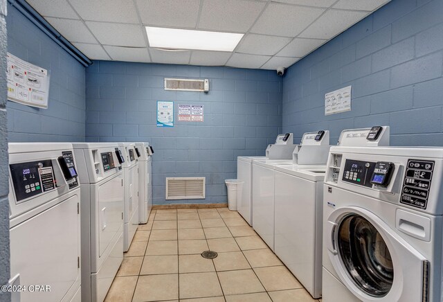 washroom with light tile patterned floors and separate washer and dryer