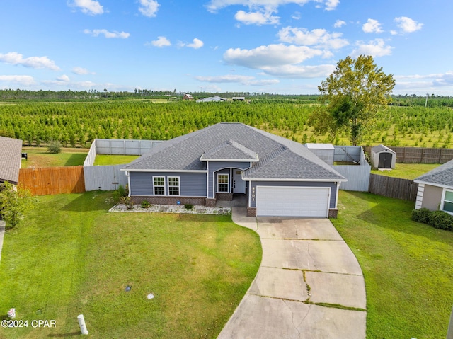 ranch-style house with a garage, a front yard, and a rural view