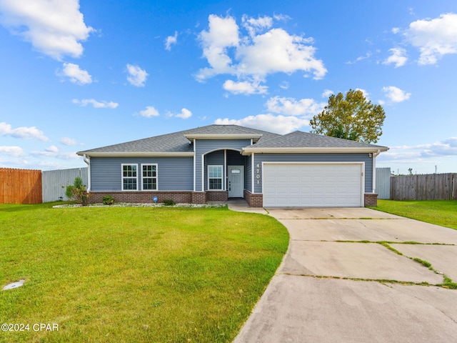 view of front of property with a garage and a front lawn