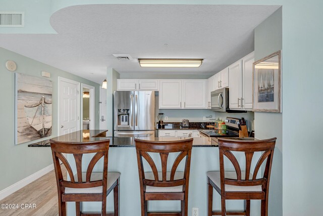 living room featuring light hardwood / wood-style floors and ceiling fan