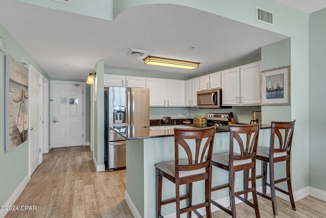 laundry area with light hardwood / wood-style floors