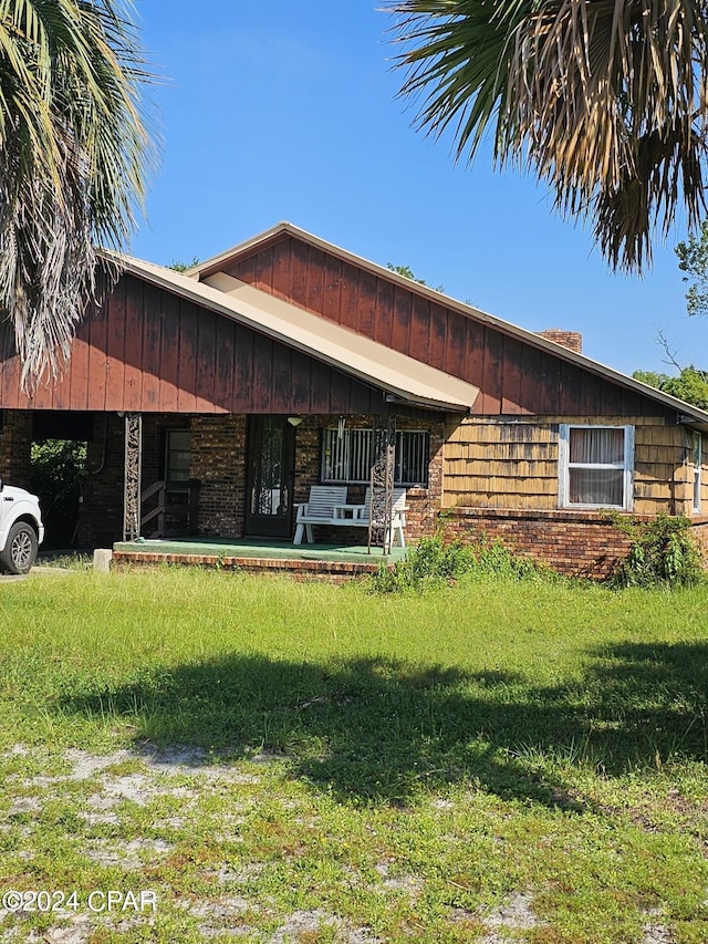 2510 W 18th St, Panama City, FL 32405 - view of front of house featuring a front lawn and brick siding