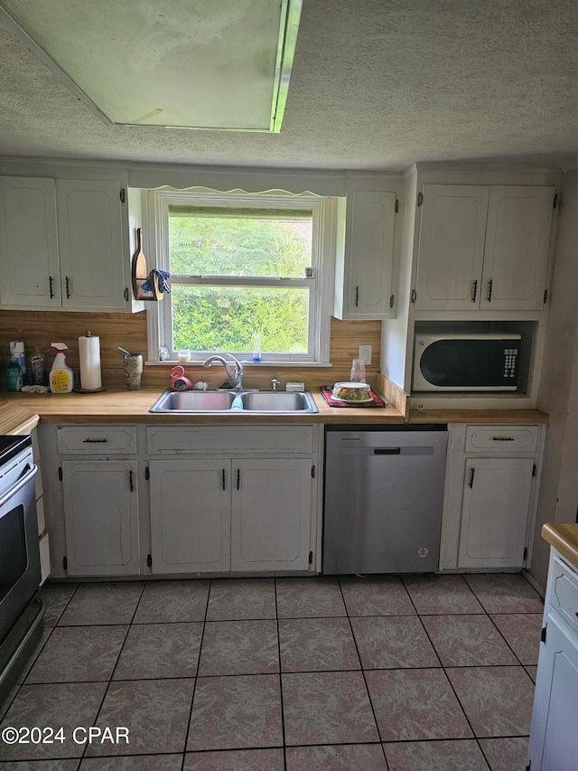 kitchen featuring white cabinets, stainless steel appliances, and sink