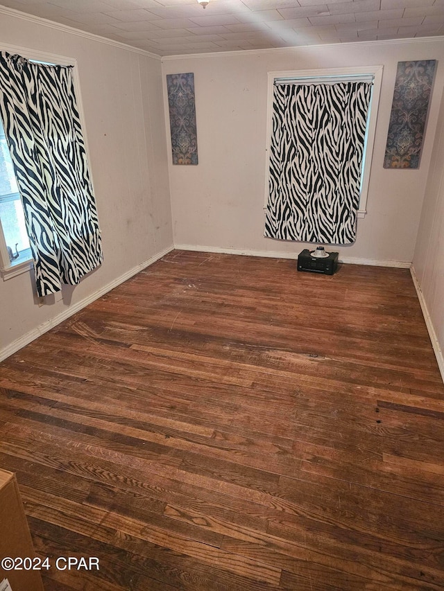 unfurnished room featuring dark hardwood / wood-style floors and crown molding