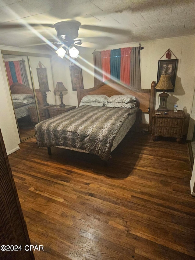 bedroom featuring a closet, ceiling fan, and dark hardwood / wood-style flooring