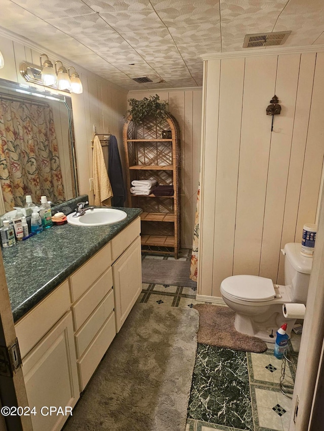 bathroom featuring vanity, wood walls, toilet, and a shower with shower curtain