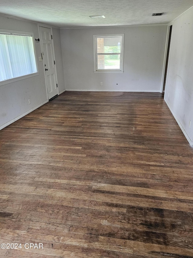 2510 W 18th St, Panama City, FL 32405 - unfurnished room with visible vents, a textured ceiling, and dark wood-style floors