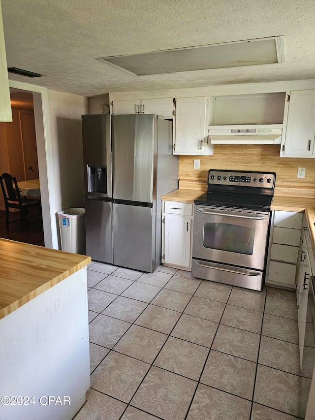 kitchen featuring stainless steel appliances, white cabinets, a textured ceiling, and light tile patterned flooring