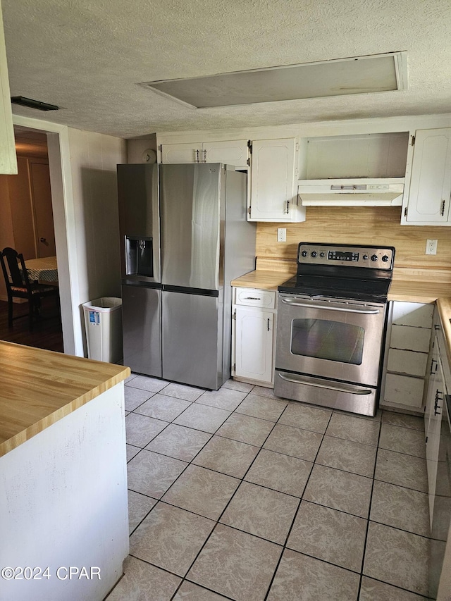 2510 W 18th St, Panama City, FL 32405 - kitchen featuring a textured ceiling, appliances with stainless steel finishes, light tile patterned flooring, and under cabinet range hood