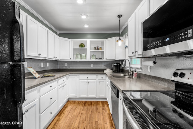 kitchen with white cabinetry, stainless steel appliances, sink, and light hardwood / wood-style floors