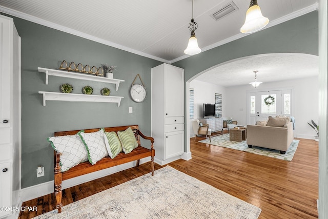 living room featuring ornamental molding and wood-type flooring