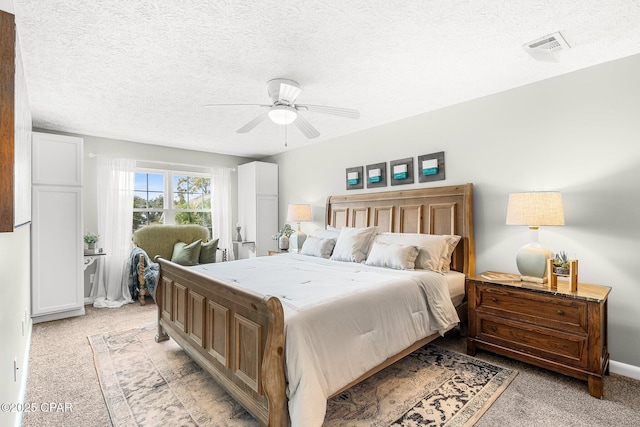 carpeted bedroom with a textured ceiling and ceiling fan