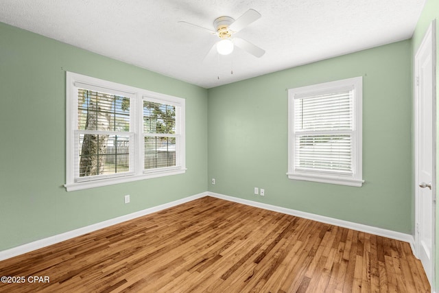 spare room featuring hardwood / wood-style flooring and ceiling fan