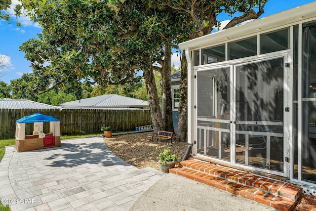 view of patio / terrace with a sunroom