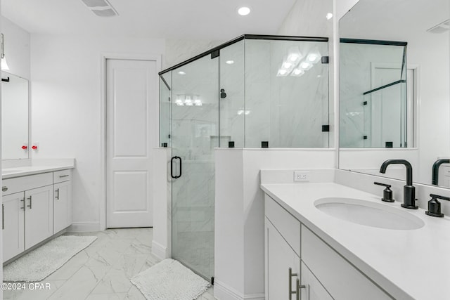 bathroom featuring walk in shower and vanity