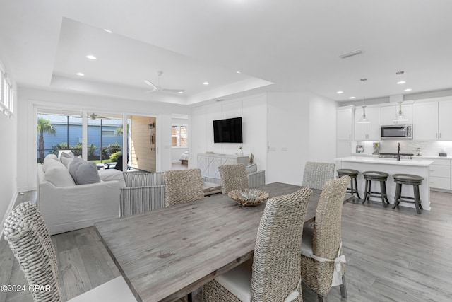 dining area with ceiling fan, light hardwood / wood-style flooring, and a wealth of natural light