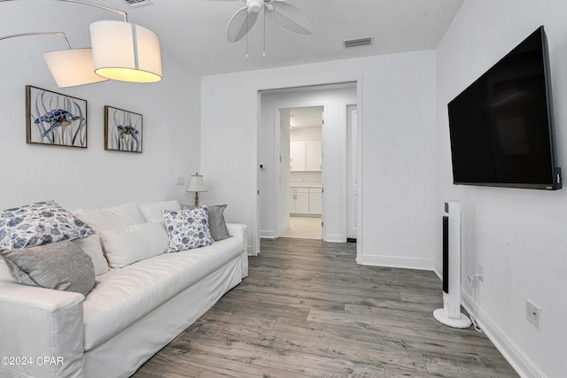 living room featuring ceiling fan and hardwood / wood-style flooring